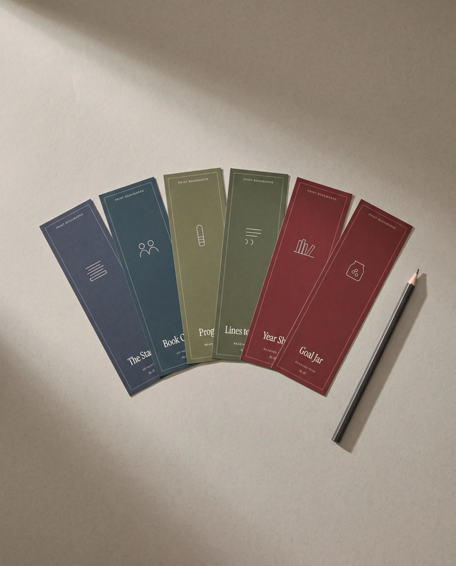 Six bookmarks fanned out on stone-grey paper.