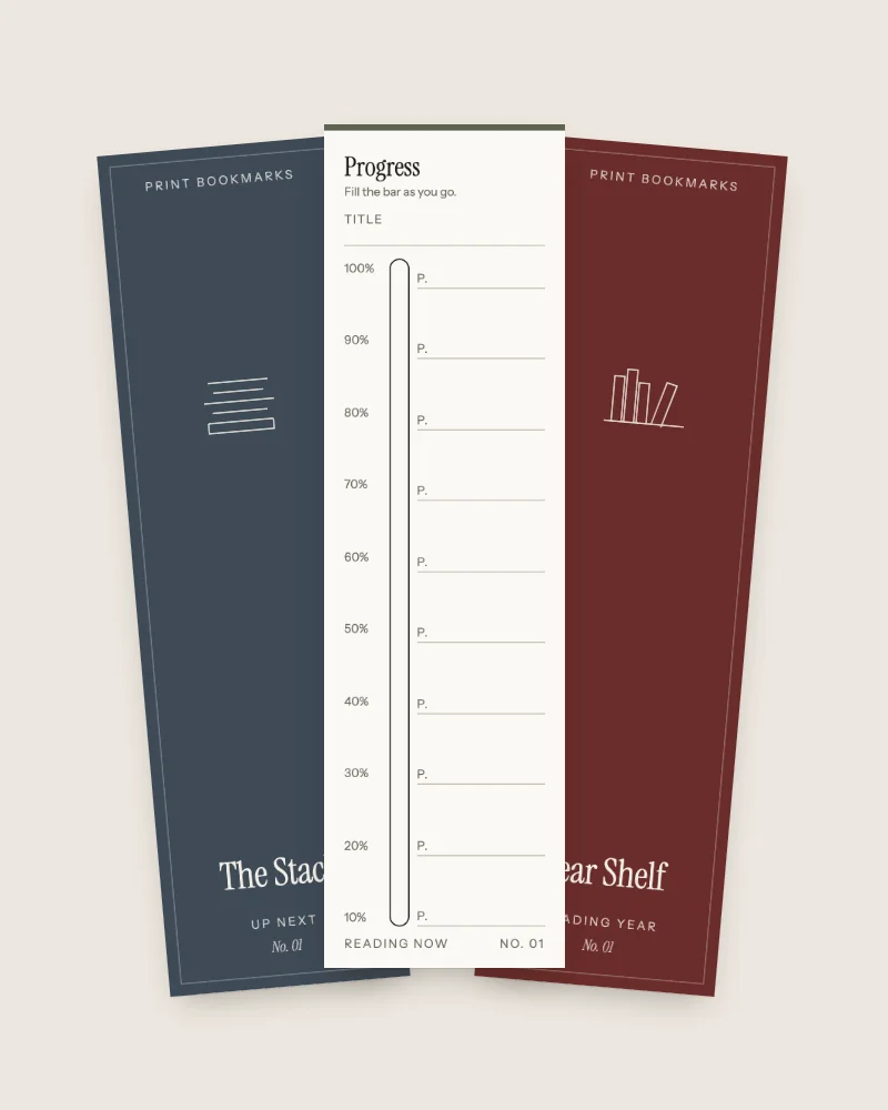 Three upright bookmarks fanned out on a pale background. A navy one titled The Stack on the left, a cream one titled Progress in the middle with a tall bar to fill and numbered page lines, and a deep red one titled Year Shelf on the right.